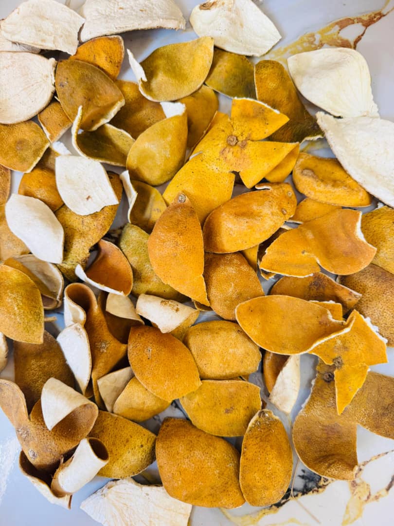 Whole dried orange peel pieces showing rich amber colour