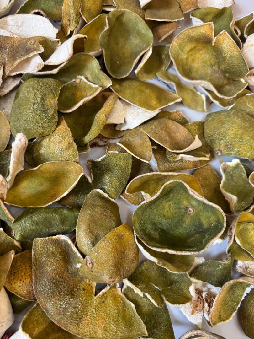 Green-cured dried orange peels ready for grading